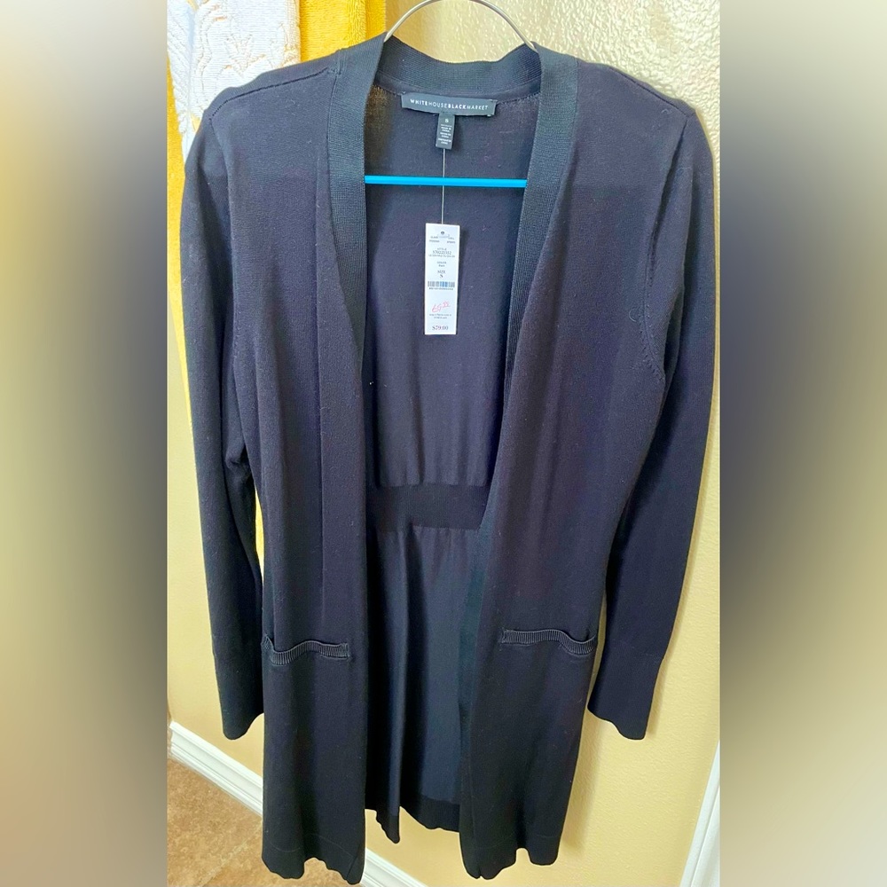 New black cardigan sweater with gold buttons on sleeve.